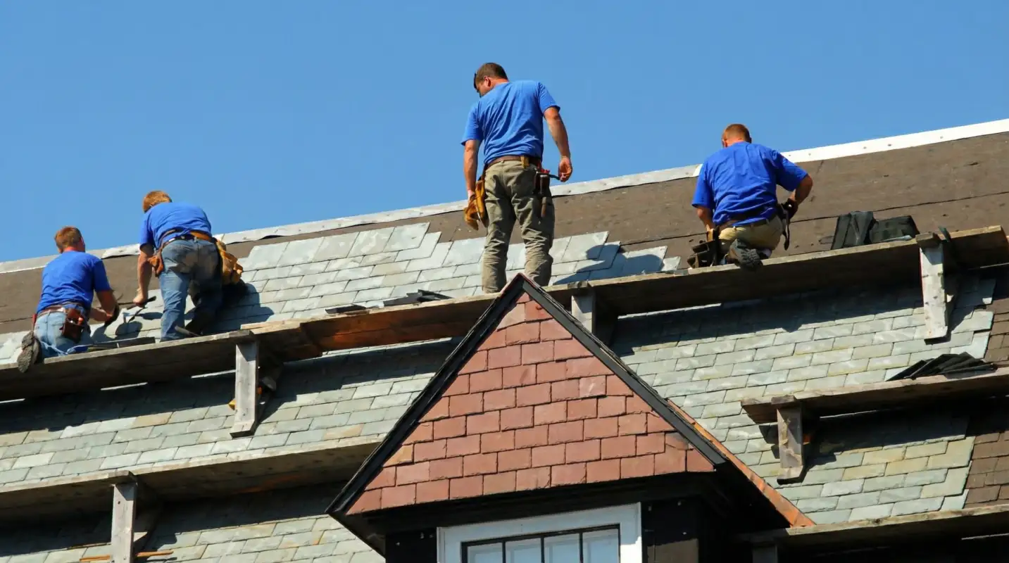 Roof replacement in progress with a team of professional contractors installing new shingles on a residential home in Memphis, TN