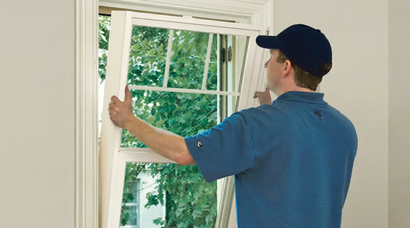 Professional contractors performing a residential window insulation and replacement service in Memphis, TN